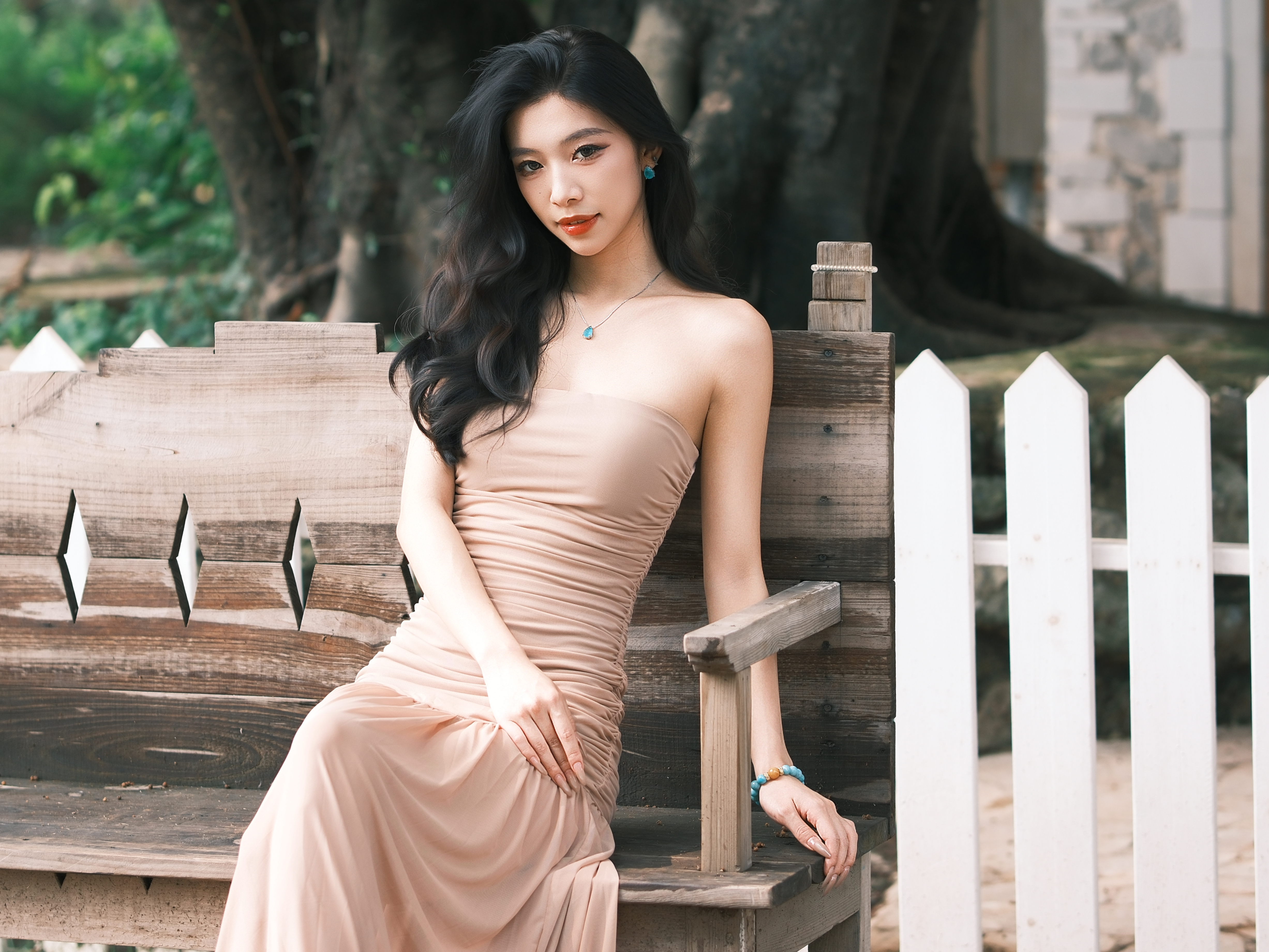 Soft portrait seated near a bench