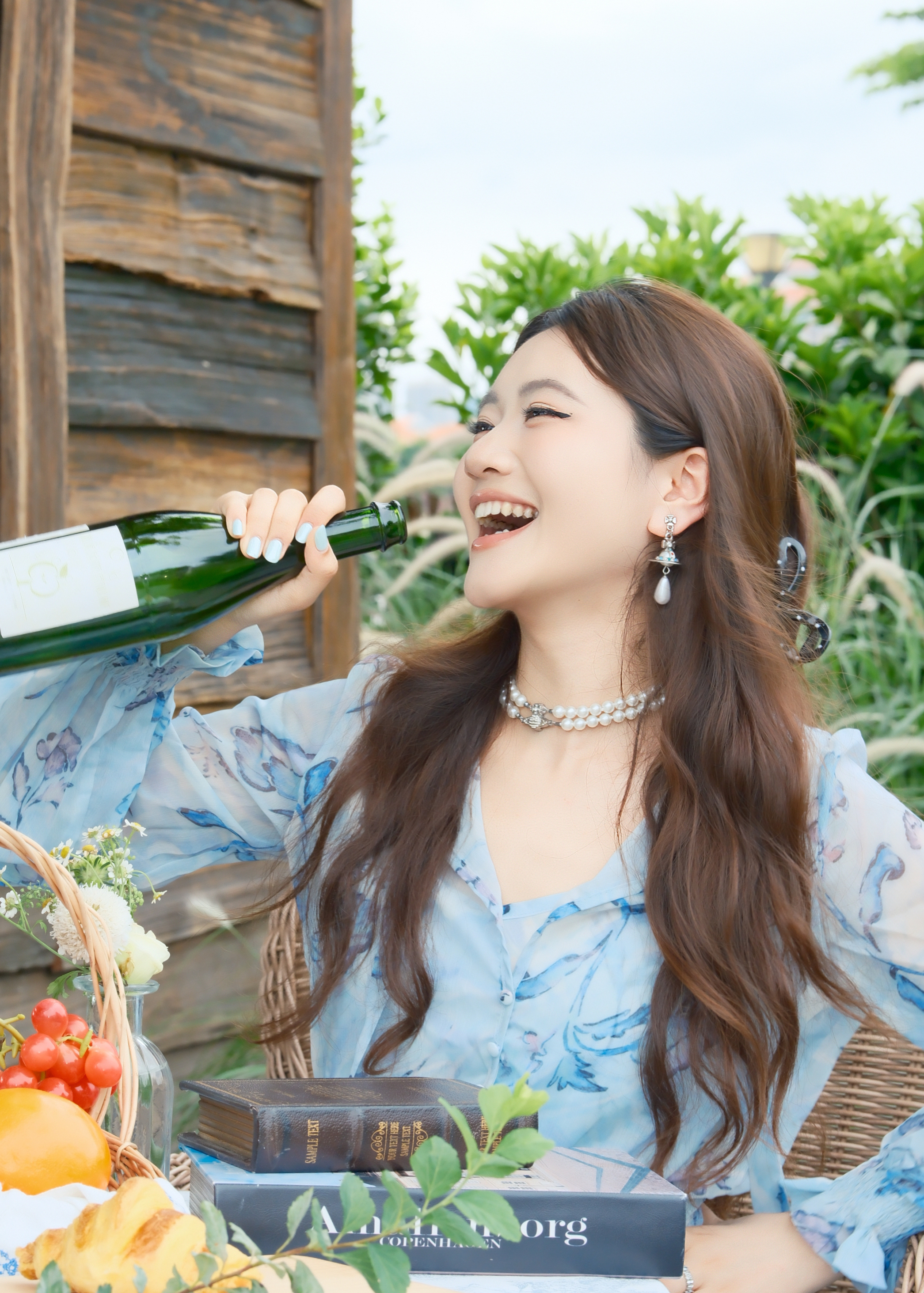 Portrait raising a glass at a market table