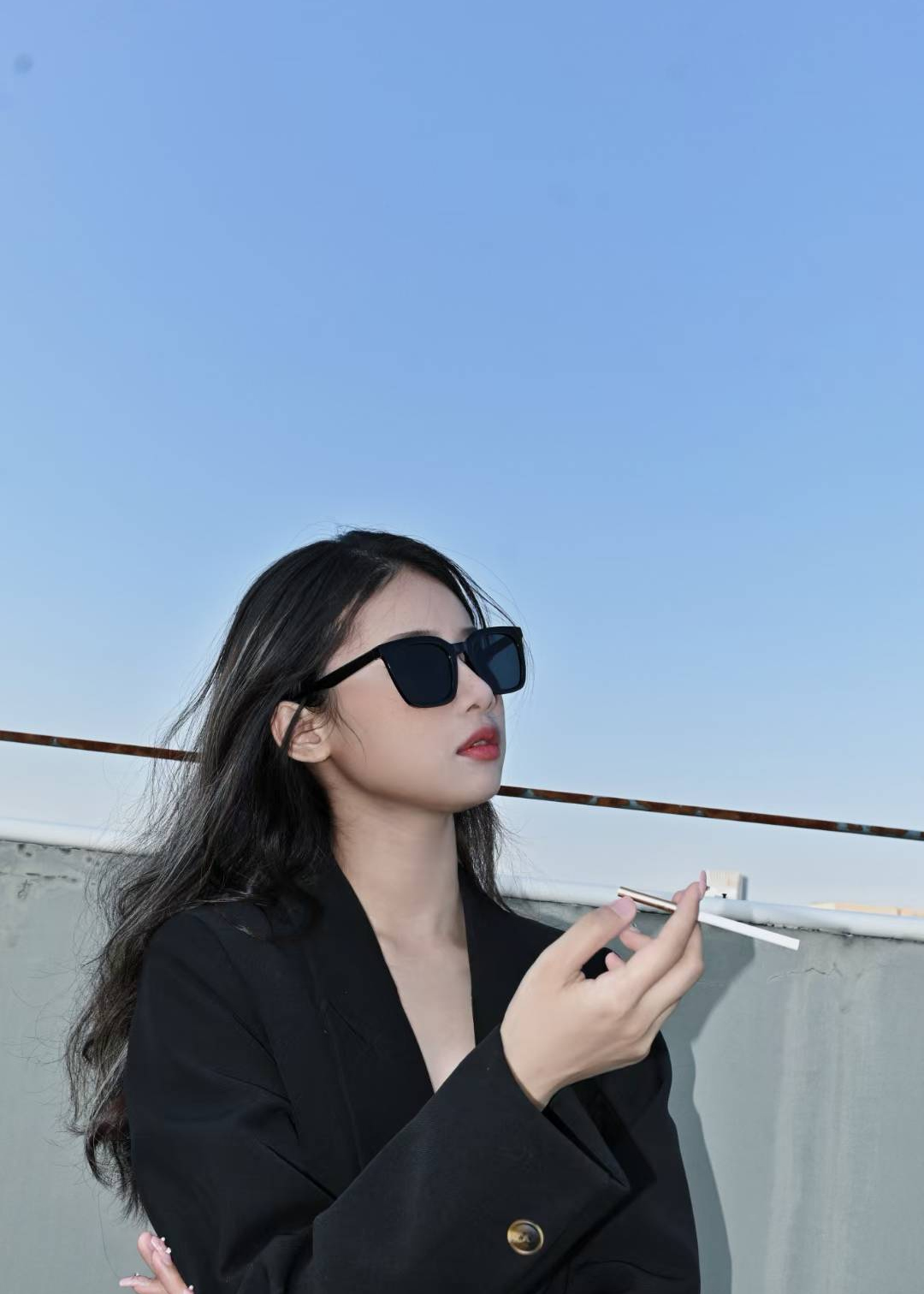 Rooftop portrait wearing sunglasses