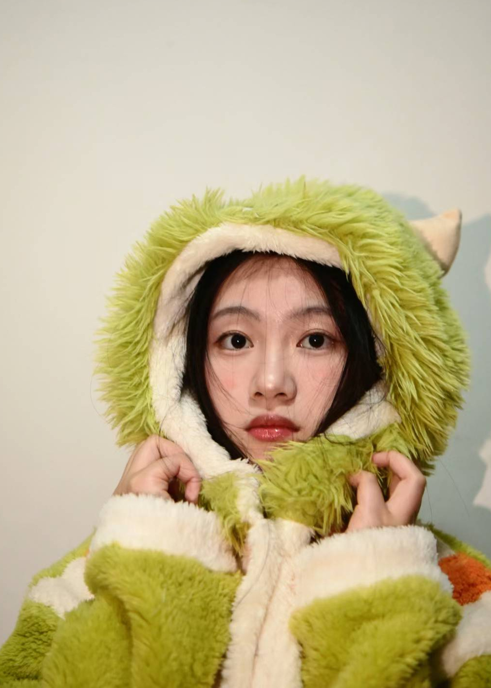 Portrait in a fuzzy green hat and coat